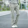 Pantalones casuales rectos holgados de algodón puro de alta gama populares para hombre, pantalones de negocios elásticos versátiles de pierna ancha de moda para el otoño de 2026