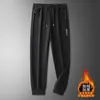 Pantalones casuales gruesos con forro polar para hombre, pantalones deportivos de otoño e invierno, corte holgado, versátiles, pantalones rectos con puño, pantalones largos para hombre