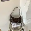 Bolso de axila para mujer 2026 Primavera Nuevo estilo Cremallera plateada Decoración Bolso de hombro Moderno de alta gama Bolso de trabajo Bolso cruzado