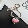 Lanyard para teléfono único y creativo con forma de corazón de goteo de aceite y diseño de hueso de serpiente, llavero para coche nuevo y colgante para bolso