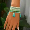 Pulsera apilada de cuentas de semillas con colgante de borla de cuentas bohemia más vendida transfronteriza con un diseño geométrico de alta gama
