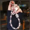 Frasco de perfume de alta qualidade, luxuoso, em formato de coração, corrente de celular de pérola e cristal, chaveiro curto, pingente de bolsa, novo estilo