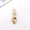 Colgante de gatito lindo de aleación estilo japonés Llavero de coche mini Colgante para AirPods Accesorio para bolso pequeño