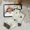 Calcetines de mujer estilo coreano para otoño 2026 con cachorros bordados de dibujos animados, calcetines de media pantorrilla, calcetines de algodón holgados a rayas con lazo estilo japonés