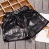 Shorts de couro para meninas para usar por cima, versátil estilo novo 2026, calças infantis de couro PU da moda para primavera e outono para crianças maiores no outono