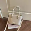 Bolsa pequena de alta qualidade com textura tecida de nicho para mulheres 2026 nova elegante versátil bolsa transversal bolsa de balde de mão estilo ins