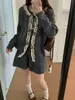 Conjunto de punto suave estilo coreano 2026 otoño e invierno nuevo cárdigan suéter con cordones + falda de cintura alta conjunto de dos piezas para mujer