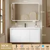 Tocador de baño engrosado y ahorrador de espacio con diseño en color crema, que cuenta con un lavabo redondeado, lavabo cerámico integrado y un lavabo de una sola pieza.