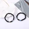 Accesorios de explosiones transfronterizas piedra volcánica negra mate de 8 mm piedra de ámbar fósil de viento pulseras de yoga para hombres y mujeres al por mayor