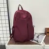 Mochila de viaje de color sólido elegante para viajes cortos, estilo japonés, bolso de doble hombro estilo ins, estilo simple, modelo para pareja, acabado mate minimalista relajado