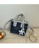 Bolsa Pequeña Popular de Color Contrastante para Mujer 2025 Nueva Moda Versátil Bolso Cruzado Estilo Extranjero Bolso de Cubo de Mano