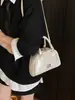 Bolsa de boliche de nicho para mujer, nuevo bolso de mano pequeño de moda 2026, diseño casual versátil, bolso de hombro y cruzado