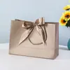 Saco de presente de arco saco de embalagem de roupas saco de cosméticos atacado saco de compras fita cor sacola logotipo