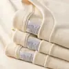 Al por mayor 230 gramos de camiseta blanca de algodón con hombros caídos pesados, manga corta, para hombre y mujer, color liso suelta, camiseta básica de marca de moda
