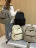 Mochila de tela de nailon ligera y duradera de color sólido con un tacto de alta gama, adecuada tanto para hombres como para mujeres, multibolsillos, mochila de gran capacidad para negocios y viajes.