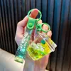 Llavero de fruta relleno de aceite, lindo colgante de bolsa de botella de arena líquida, llavero de coche, pequeños regalos para máquinas expendedoras, al por mayor