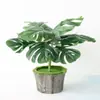 Paquete de simulación al por mayor hojas estilo nórdico para el hogar planta de simulación verde flor artificial 9 cabezas hoja de caparazón de tortuga