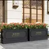 Caja de flores de acero inoxidable para exteriores combinación soporte de flores de hierro departamento de ventas valla de plantación verde partición canaleta para flores cama de flores exterior de restaurante