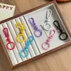 Llavero de macarrón pintado de primavera, colgante creativo para bolso, llavero de metal colorido, venta al por mayor de accesorios
