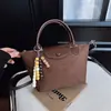 Nuevo bolso de mano pequeño transfronterizo 2026 para mujer, bolso de trabajo con un toque de alta gama, bolso versátil de hombro y cruzado, bolso tipo bollo