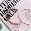 Nuevo y moderno reloj de pulsera con perlas de colores en forma ovalada, estilo de extracción de longitud libremente ajustable para mujer, de cuarzo, exquisito y compacto