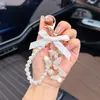 Estilo Coreano Mariposa Incrustada de Diamantes Cadena de Perlas Llavero con Colgante de Lazo Creativo Lujo Ligero Femenino Nuevo Exquisito Colgante para Bolso