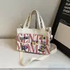 Bolsa de Ombro de Lona para Celular Estilo Tailandês Nicho Feminino 2024 Nova Simples Estampada com Letras