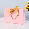 Fábrica en stock al por mayor bolsa de regalo con lazo bolsa de papel bolsa de embalaje para ropa al por mayor bolsa de cosméticos bolsa de compras mano