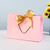 Saco de presente de arco saco de embalagem de roupas saco de cosméticos atacado saco de compras fita cor sacola logotipo