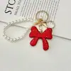 Llavero de Lujo Completo con Diamantes y Lazo de Cristal Sensación de Alta Gama Colgante de Bolso con Cadena de Perlas Tendencia de Moda Colgante de Pedrería