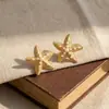 Pendientes de verano transfronterizos estilo vacación en el mar, con textura de estrella de mar, diseño minimalista de perlas de nicho, venta al por mayor