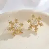 Aretes originales de copo de nieve giratorios hechos de aleación de cobre, microincrustados con circonio, pasadores de plata S925, exquisitos y de alta gama, con una atmósfera sofisticada, aretes para mujer