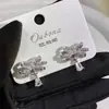 Brincos de Laço com Pedras Full Diamond e Gota d'Água com Design de Luxo Leve, Estilo Nicho de Alta Qualidade, Acessório de Moda Elegante e Versátil para Mulheres