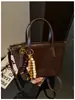 2026 Nuevo Bolso Tote de Moda Estilo Coreano Nicho Retro Bolso Cubo Versátil de Alta Gama para Uso Diario de Hombro Único o de Mano
