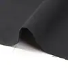 Suministro en Stock 108*58 Hilo de Poliéster Cardado Tejido de Sarga Negro Tejido Compuesto para Ropa de Trabajo para Bolsas y Equipaje