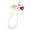 Nueva pulsera creativa de perlas con bonito colgante de aleación de corazón, llavero con cabeza de belleza, accesorios de metal, bolso de joyería para mujer