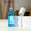 Botella de vidrio redonda recta escalonada azul transparente de 30 ml para aceites esenciales en stock, botella dispensadora cosmética con gotero de presión transparente para sérum