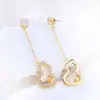 Nuevos y elegantes pendientes de perla tipo calabaza con borlas y montura calada para mujer, pendientes de alta gama, elegantes y a la moda al por mayor