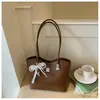 Bolso de hombro con lazo estilo coreano 2026 transfronterizo para mujer, bolso de axila de nicho, bolso tipo cubo moderno y simple para el trabajo diario para mujer