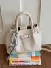 Bolso tipo cubo versátil para el verano 2026, simple y elegante, nuevo bolso de mano de moda, estilo coreano, bolso de hombro cruzado