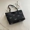 Bolso tote de lona de moda nuevo 2026 para mujer, estilo casual y dulce con un moño, gran capacidad, se puede llevar en la mano o usar como bolso de hombro