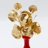 Folhas artificiais de eucalipto, folhas artificiais de ginkgo e leques de três folhas para decorações de casamento, em tons dourados.