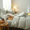 Juego de cuatro piezas de algodón 100% teñido en hilo y lavado personalizado, sábana y funda de edredón de color liso y algodón puro, ropa de cama adecuada para todas las estaciones