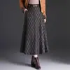 Saia xadrez de lã para mulheres, novo estilo outono e inverno 2026, cintura alta, estilo college, comprimento médio, saia elegante e moderna em linha A para mulheres