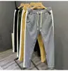 Nueva colección de primavera y otoño: pantalones casuales a rayas de bloques de color para hombre, modernos y elegantes, de pierna recta de alta gama, corte ajustado y deportivos largos