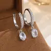 Pendientes de aro con incrustaciones de diamantes, dorados, de lujo ligero, para mujer, con colgante de circonita ovalada, simples y versátiles, para cruzar fronteras