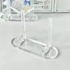 Soporte de exhibición de insignias de acrílico con diseño de ondas de agua Nuevo soporte de almacenamiento creativo de alta calidad para escritorio