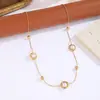 Collar espaciador de perlas retro más vendido transfronterizo, acero inoxidable con gema azul y diseño de pez pequeño, cadena larga en Y para suéter con incrustaciones de diamantes