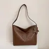 Bolso de mano de alta calidad con textura tejida 2026 nuevo elegante simple para llevar en la mano alto valor estético textura bolso de un solo hombro para debajo del brazo