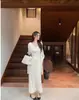 Elegante y suave conjunto de tres piezas estilo coreano para otoño, con una camisola de talla grande de corte holgado, un cárdigan y una falda